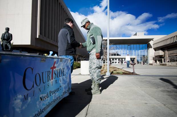 Courtside Ministries volunteer Quentin Valdois, left, offers a prayer for Corey Trusty as he leaves the El Paso County Terry R. Harris Judicial Complex